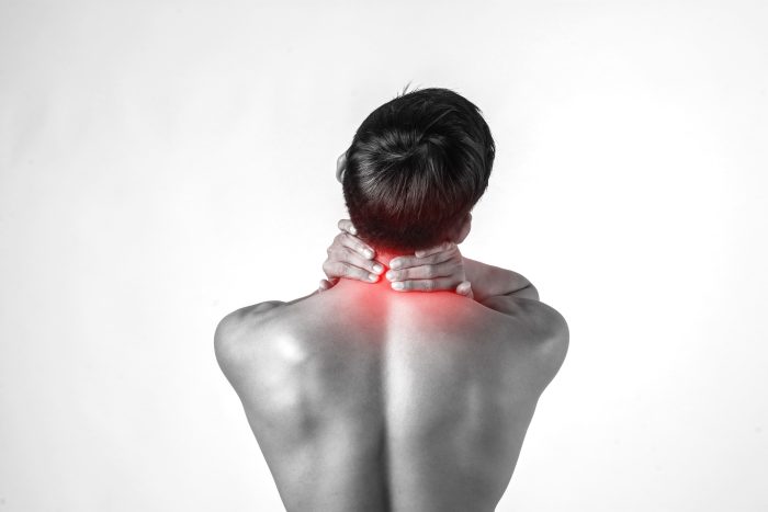 Moreau Matthieu Osteopathie Du Sportif Valbonne Muscular Man Use Handles Neck Relieve Pain Isolated White Background 1 700x467 1
